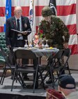 Chaplain (Maj.) Richard Weinhagen, a chaplain with the Vermont State Guard, places a candle at the POW/MIA table during the POW/MIA Day observance at Camp Johnson, Vermont, on Sept. 16, 2022. POW/MIA Day is observed the third Friday of September to honor veterans who were held as prisoners of war or who were missing in action. (U.S. Army National Guard photo by Don Branum)