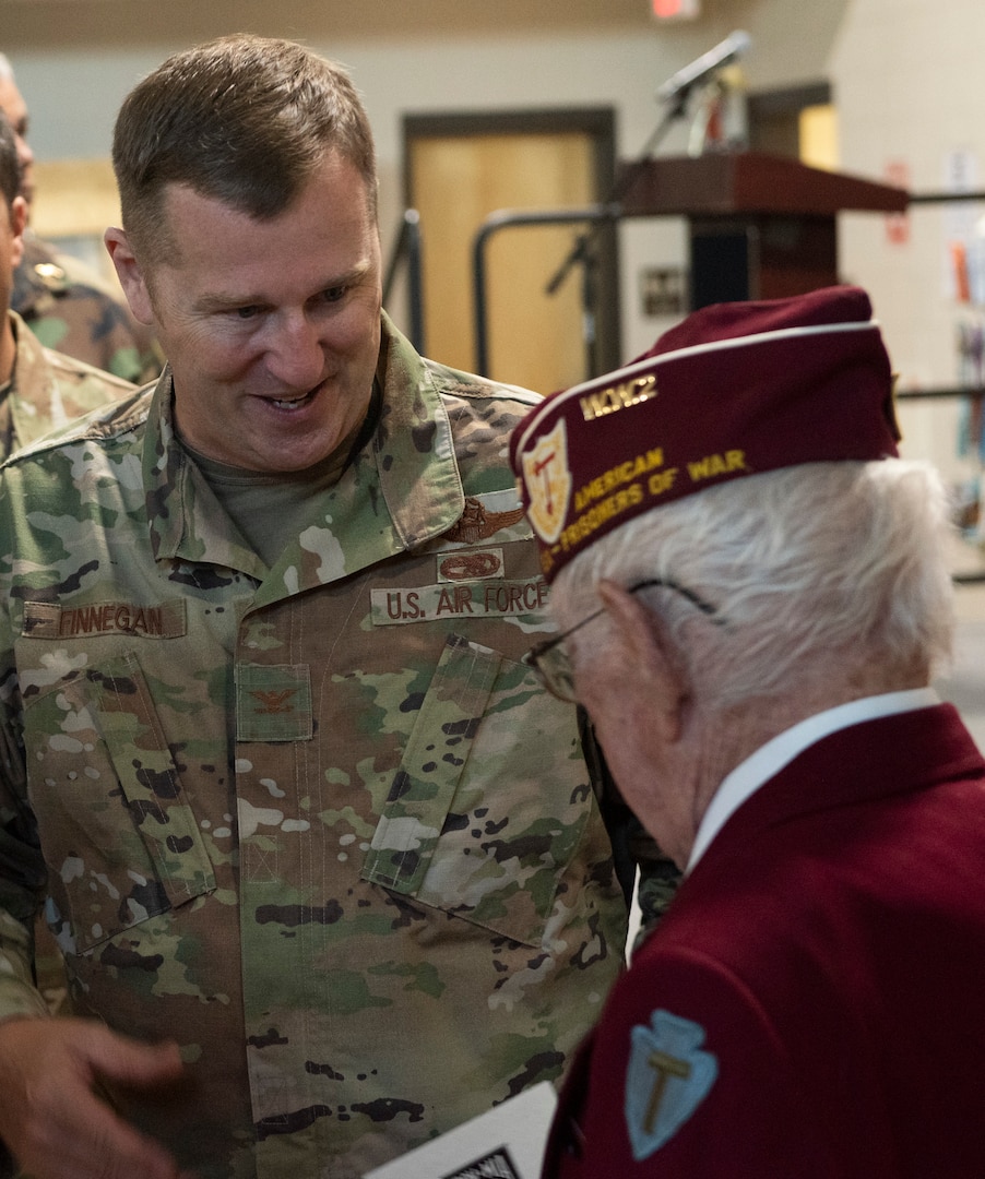 Col. Daniel Finnegan, commander of the Vermont Air National Guard's 158th Maintenance Group, speaks with Clyde Cassidy after the POW/MIA Day observance at Camp Johnson, Vermont, on Sept. 16, 2022. POW/MIA Day is observed the third Friday of September to honor veterans who were held as prisoners of war or who were missing in action. Cassidy is a World War II POW who was who endured a 70-day forced march across parts of Europe at the hands of the Nazis. (U.S. Army National Guard photo by Don Branum)