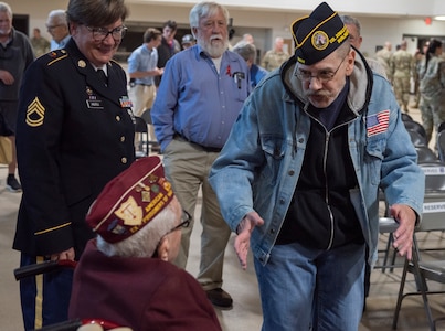 Randall Roberts greets William B. Busier after the POW/MIA Day observance at Camp Johnson, Vermont, on Sept. 16, 2022. POW/MIA Day is observed the third Friday of September to honor veterans who were held as prisoners of war or who were missing in action. Busier was captured by Nazi Germans and held at Stalag Luft 9A for six months. Roberts is former commander of the Col. Donald G. Cook chapter of the Disabled American Veterans charity. (U.S. Army National Guard photo by Don Branum)