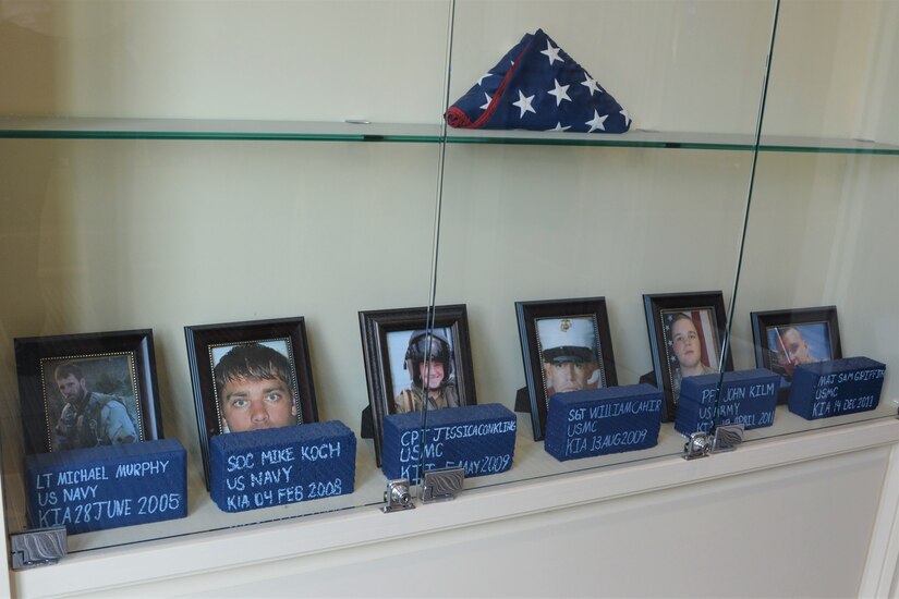 A display in the Penn State Student Veteran Center features photos of Penn State graduates who were killed in action while serving in the U.S military since 9/11. At  the far left of the display is Navy SEAL Lt. Michael Murphy, who was posthumously awarded the Medal of Honor for actions in Afghanistan in 2005.