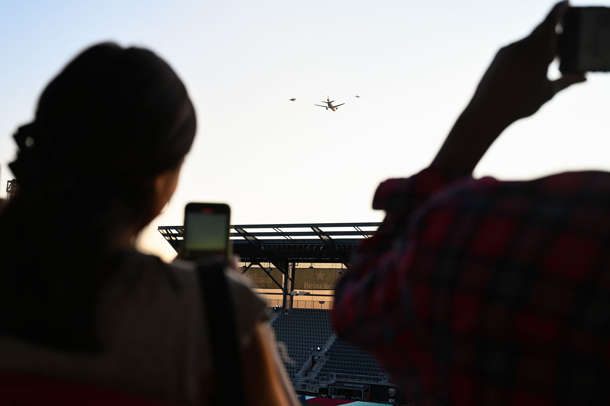 Attendees of the Air Force 75th Anniversary Tattoo capture photos of the aerial parade Sept. 15, 2022, at Audi Field, Washington, D.C. The aerial parade included P-51 Mustang, B-25 Mitchell, B-17 Flying Fortress, F-15 Eagle, F-16 Fighting Falcon, F-22 Raptor, F-35 Lightning II, KC-10 Extender & KC-46 Pegasus aircraft flyover the Air Force 75th Anniversary Tattoo Sept. 15, 2022, at Audi Field, Washington, D.C. (U.S. Air Force photo by Staff Sgt. Nilsa Garcia)