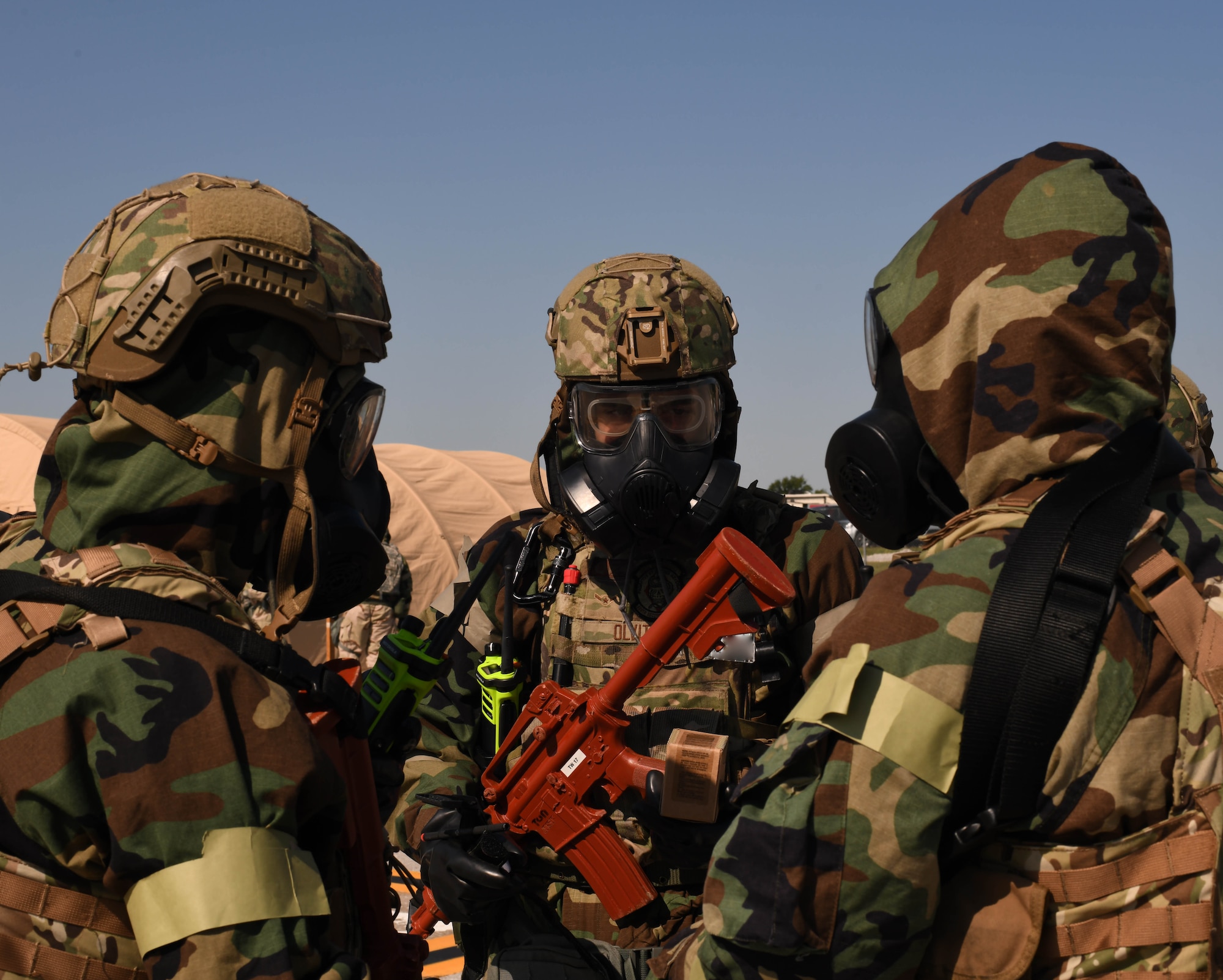 U.S. Air Force Airmen discuss details about a CBRN exercise at Whiteman Air Force Base, Missouri, September, 15, 2022. MOPP gear is protective equipment worn in CBRN-contaminated environments meant to protect an individual from CBRN agents. This CBRN training utilized MOPP gear to ensure Airmen are ready to respond and defend its personnel and assets. (U.S. Air Force photo by Airman 1st Class Hailey Farrell)