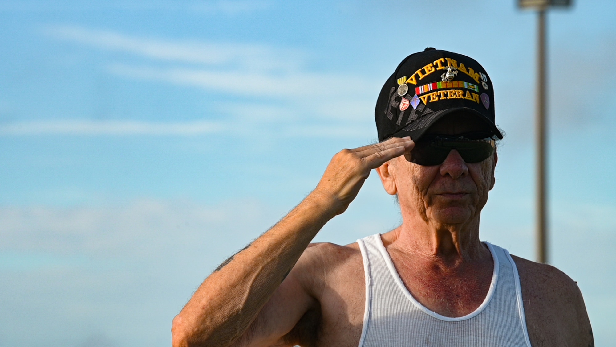 A Vietnam veteran renders a salute during the national anthem before participating in a prisoner-of-war/missing in action 24-hour run at MacDill Air Force Base, Florida, Sept 15, 2022. The National League of Families of American Prisoners and Missing in Southeast Asia was created during the Vietnam war and has been working to bring home the 1,582 Americans still missing from that conflict. (U.S. Air Force photo by Airman 1st Class Michael Killian)
