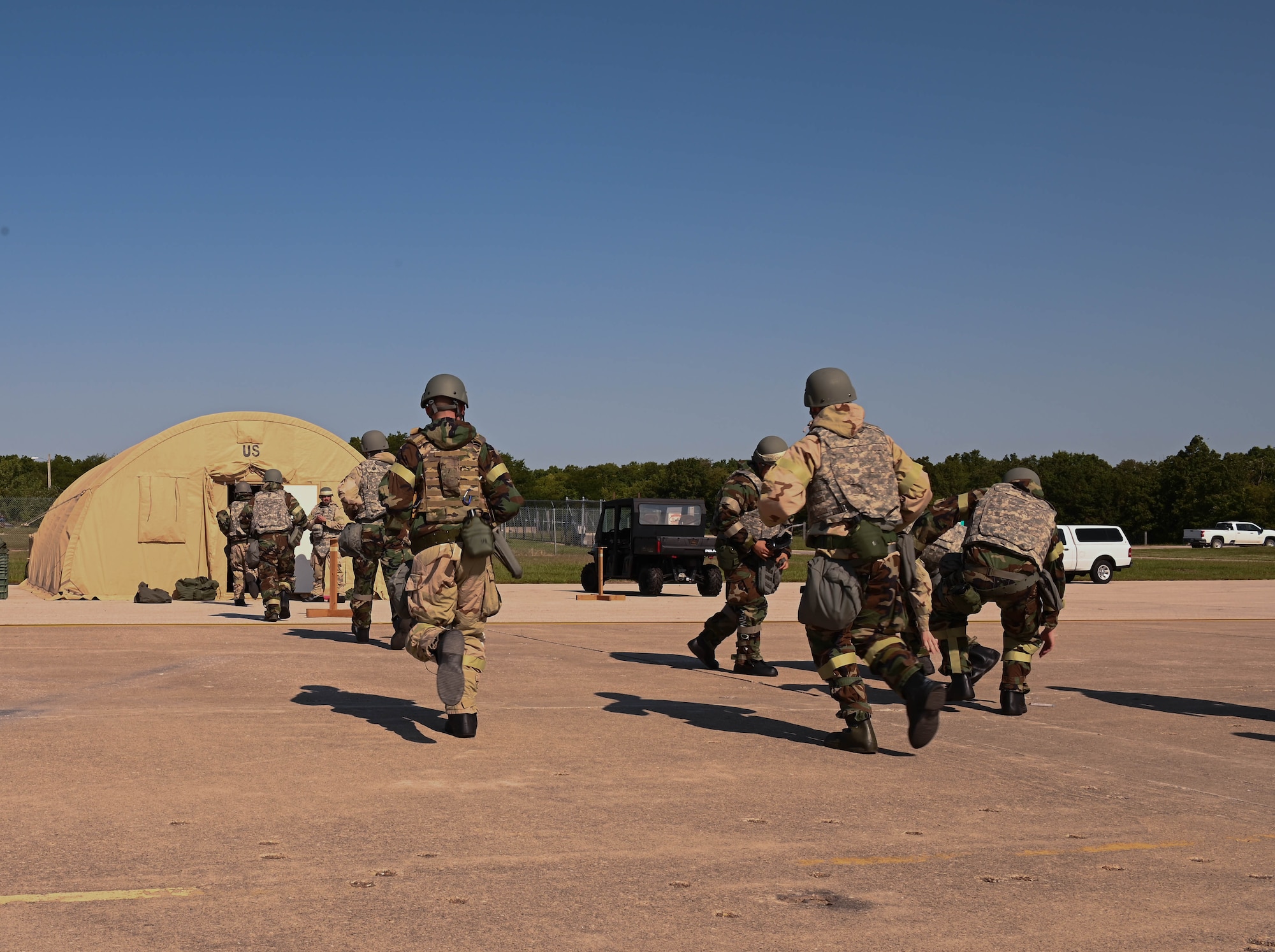 U.S. Air Force Airmen rush to shelter during a CBRN exercise at Whiteman Air Force Base, Missouri, September 15, 2022. Training such as this ensures Airmen are resilient, equipped and combat-ready. (U.S. Air Force photo by Airman 1st Class Hailey Farrell)