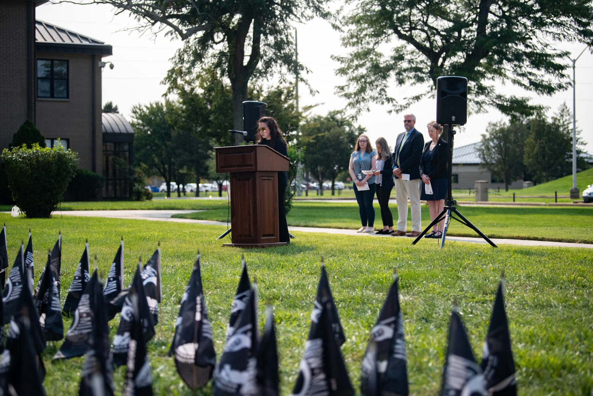 Hallie Stinebuck, Armed Forces Medical Examiner System supervisor DNA analyst, reads a list of repatriated service members during a retreat ceremony commemorating National POW/MIA Recognition Day at Dover Air Force Base, Delaware, Sept. 16, 2022. Members of the AFMES past accounting and DNA registry operations read names of service members who were repatriated this year. (U.S. Air Force photo by Senior Airman Faith Barron)