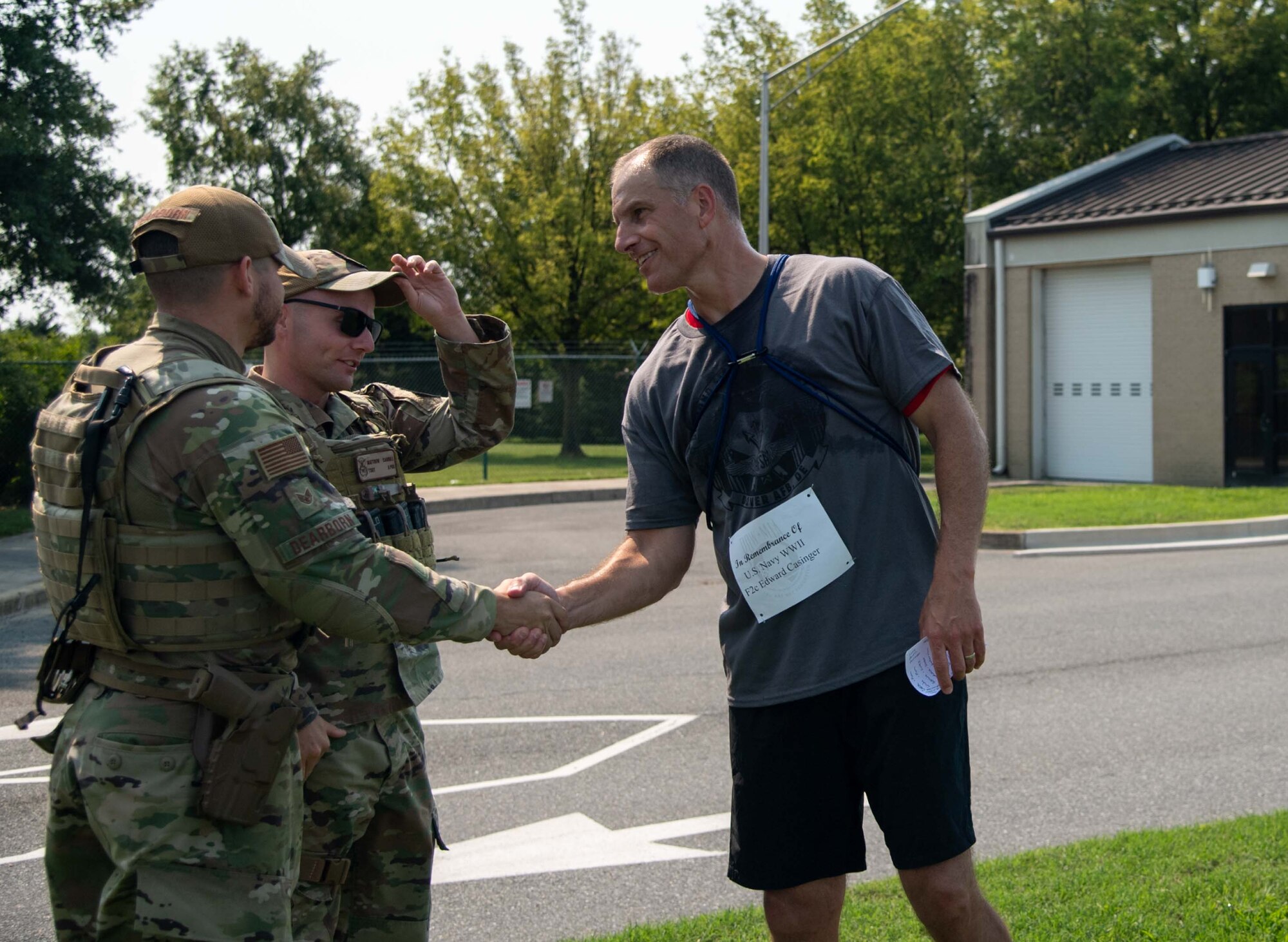 Col. Matt Husemann, right, 436th Airlift Wing commander, thanks a defender after running in a POW/MIA memorial 5k in Dover, Delaware, Sept. 16, 2022. Units from across Dover Air Force Base participated in the 5k leading up to a retreat ceremony commemorating National POW/MIA Recognition Day. (U.S. Air Force photo by Senior Airman Faith Barron)