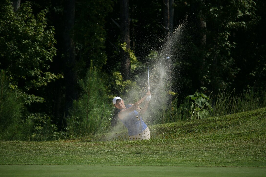 Air Force 1st Lt. Kimberly Lui of Minot AFB, N.D. lands an amazing shot out of the bunker for par during the final day of the 2022 Armed Forces Golf Championship hosted by Army at Fort Belvoir, Virgina.  Championship features teams from the Army, Marine Corps, Navy (with Coast Guard players), and Air Force (with Space Force players).  Department of Defense Photo by Mr. Steven Dinote - Released.