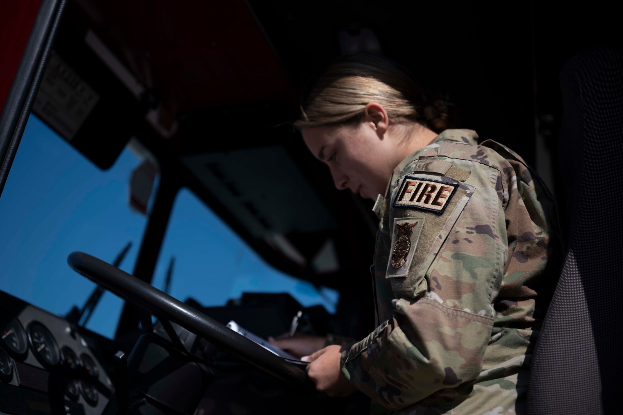 An Airman sits in a firetruck.