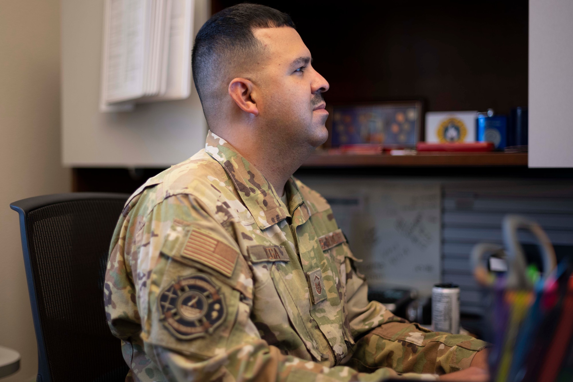 An Airman works at his office desk