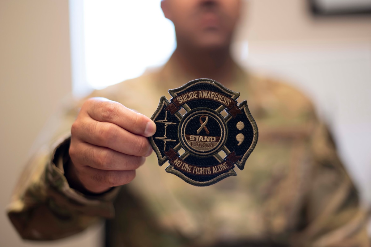 Airman holds a patch