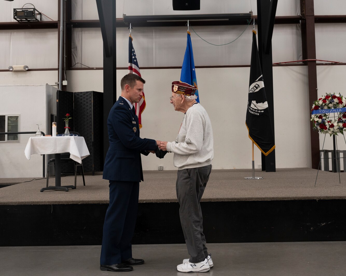 A picture of a man presenting a gift to a veteran