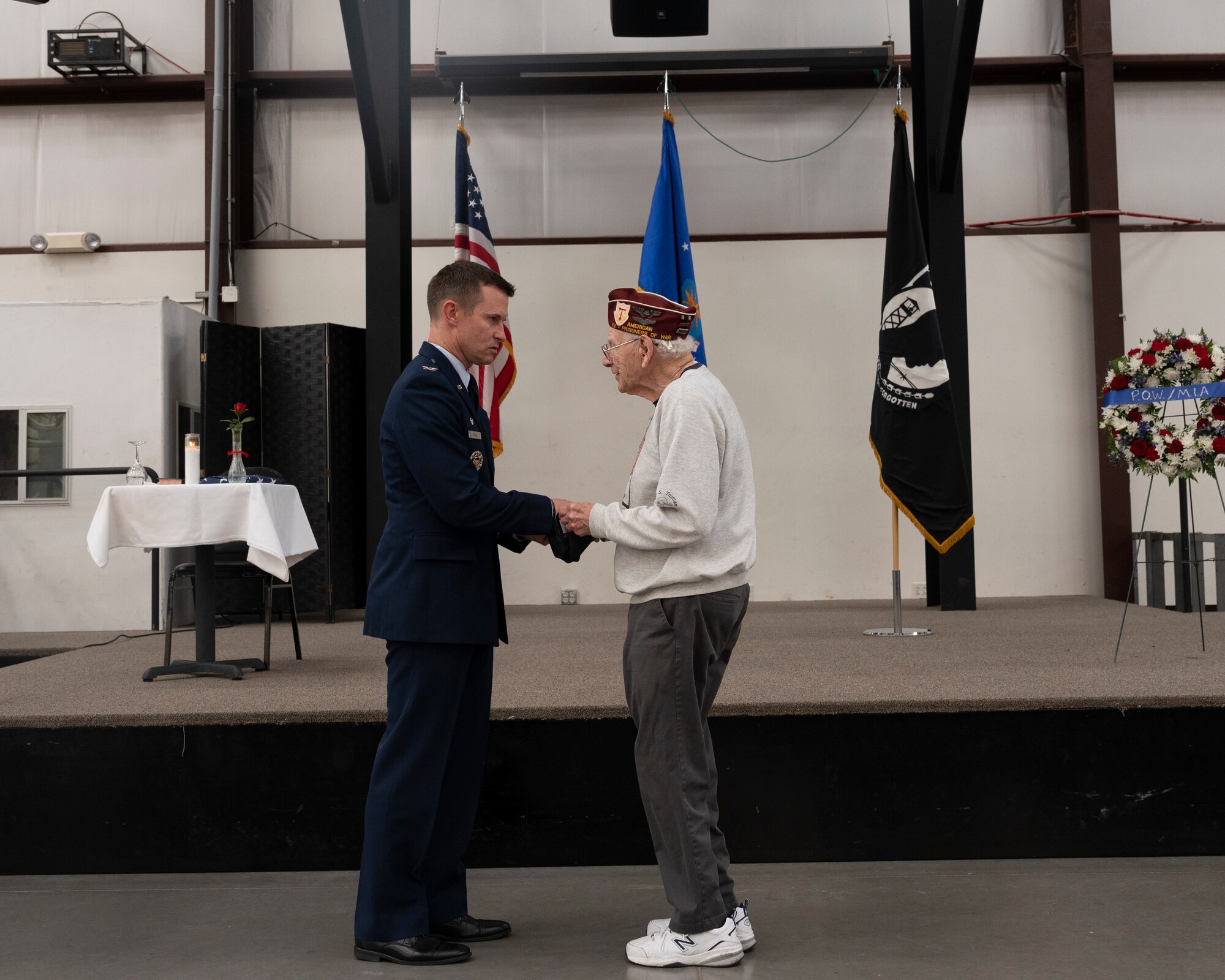 A picture of a man presenting a gift to a veteran