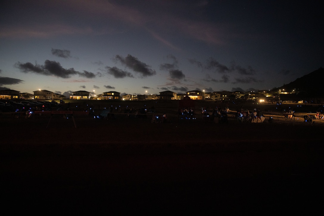 U.S. service members and their families prepare to watch a fireworks show held by the City of Kailua from Fort Hase Beach, Marine Corps Base Hawaii, July 4, 2022. MCBH facilitated the viewing area in order provide an opportunity to view the firework demonstration and to celebrate Independence Day. (U.S. Marine Corps photo by Cpl. Brandon Aultman)