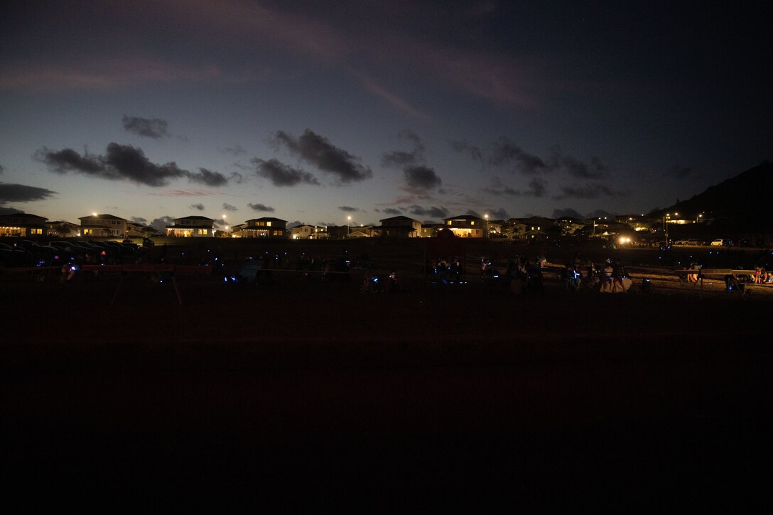 U.S. service members and their families prepare to watch a fireworks show held by the City of Kailua from Fort Hase Beach, Marine Corps Base Hawaii, July 4, 2022. MCBH facilitated the viewing area in order provide an opportunity to view the firework demonstration and to celebrate Independence Day. (U.S. Marine Corps photo by Cpl. Brandon Aultman)