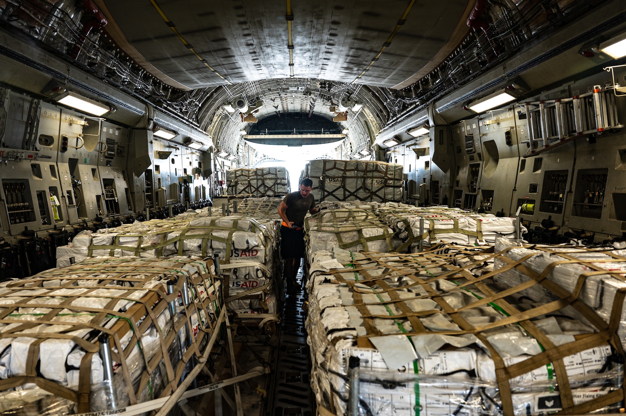 U.S. military personnel assigned to United States Central Command load critical supplies into a U.S. Air Force C-17A Globemaster III aircraft in support of a USAID-led humanitarian mission to Pakistan from Al Udeid Air Base, Qatar, Sep. 14, 2022. USAID leads the U.S. Government's international development and disaster assistance, helping people emerge from humanitarian crises, such as the catastrophic flooding currently plaguing Pakistan. (U.S. Air Force photo by Staff Sgt. Dana Tourtellotte)