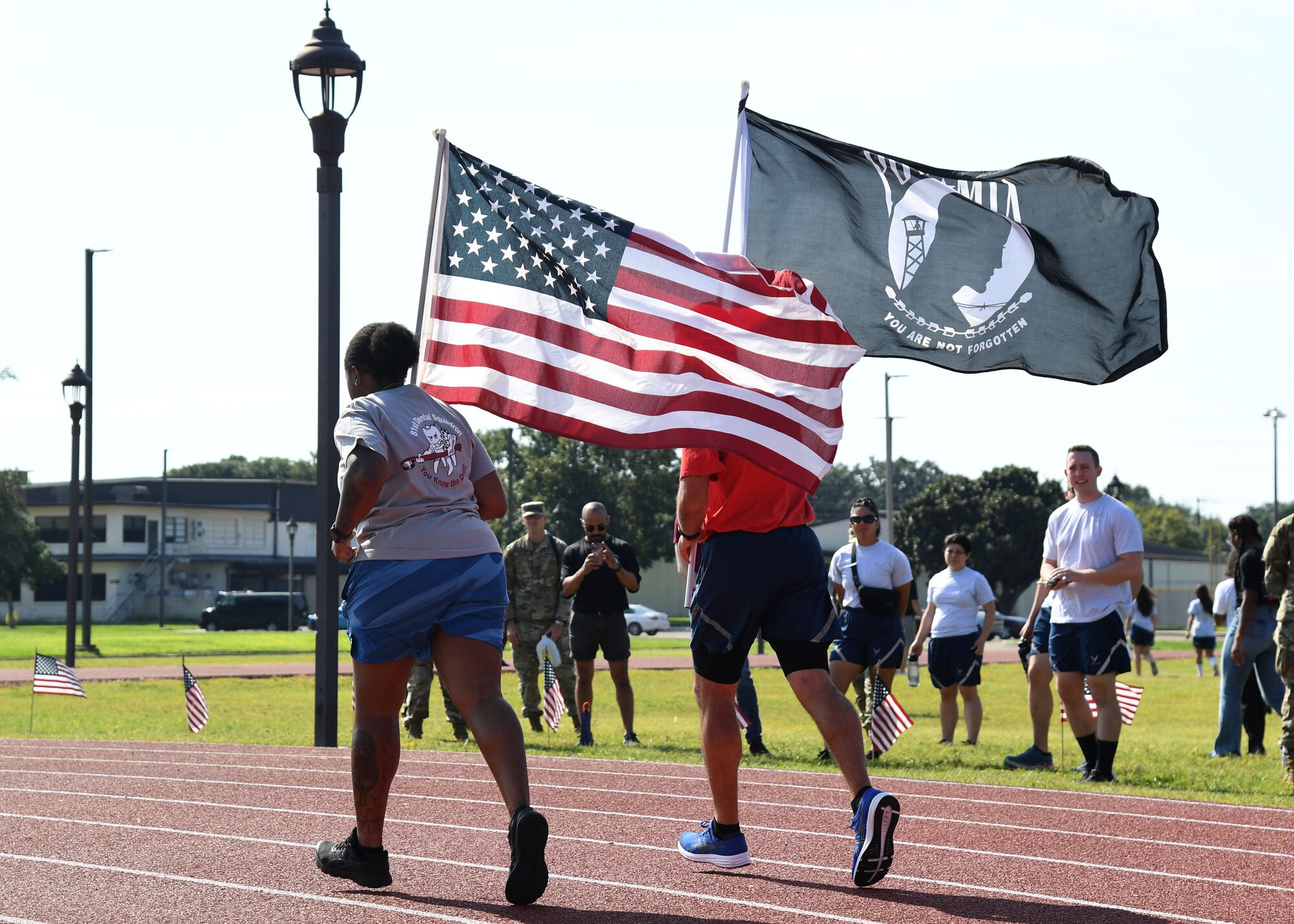 U.S. Air Force Senior Airman Destiny Sinalley, 81st Dental Squadron dental technician, and Tech. Sgt. Frankie Hitchcock, 336th Training Squadron instructor, participate in the POW/MIA run and vigil at the triangle track on Keesler Air Force Base, Mississippi, Sept. 16, 2022. The event, hosted by the Air Force Sergeants Association Chapter 652, is held annually to raise awareness and pay tribute to all prisoners of war and the military members still missing in action. (U.S. Air Force photo by Kemberly Groue)