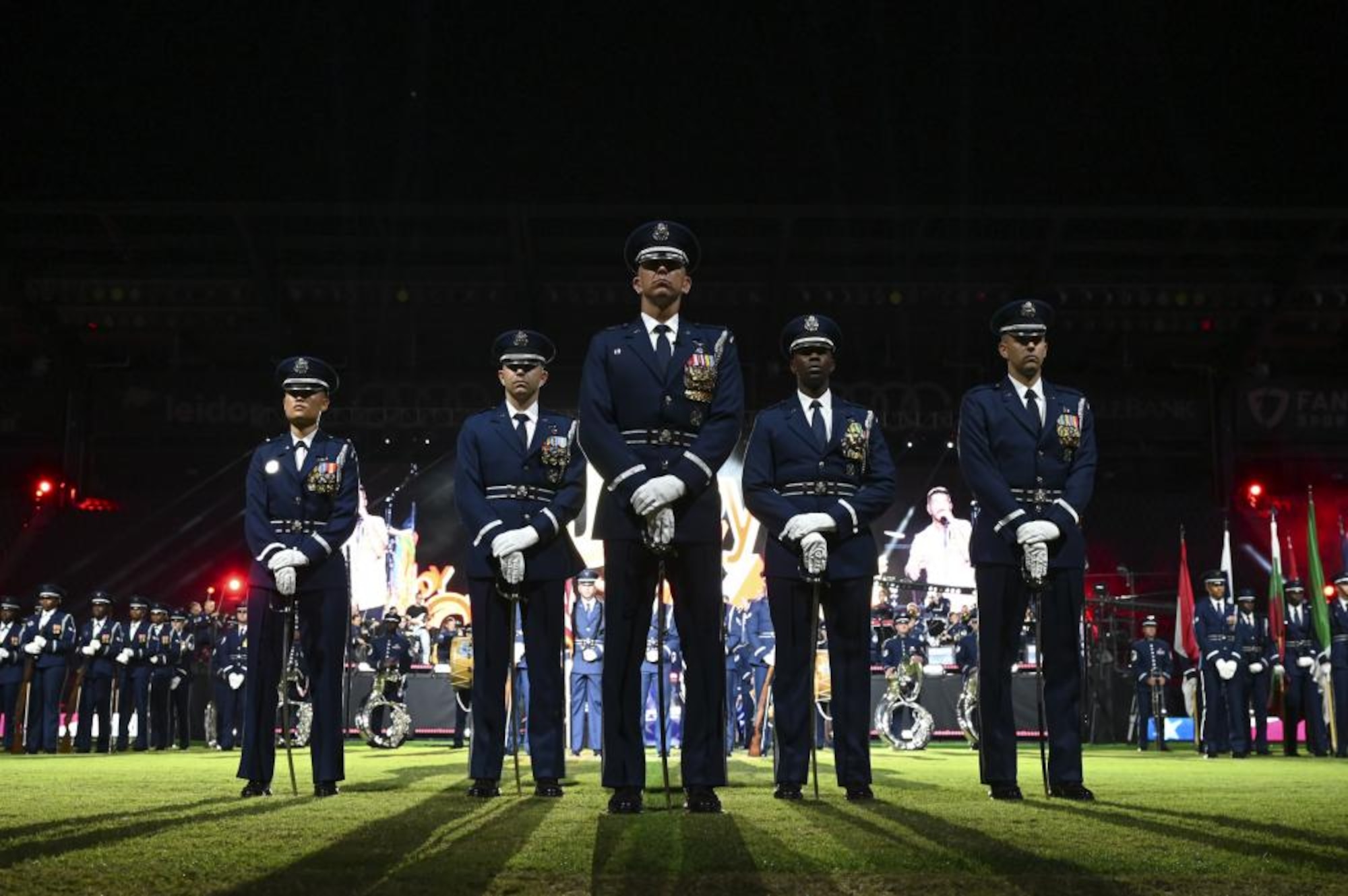 The United States Air Force Band and The United States Air Force Honor Guard Drill Team gather in formation during a performance for the Air Force 75th Anniversary Tattoo Sept. 15, 2022, at Audi Field, Washington, D.C. The military Tattoo is an historic tradition held worldwide, showcasing the excellence and readiness of service members. The members of the Band and the Honor Guard share a common mission of representing Air Force values and fostering community across the nation and with international allies. (U.S. Air Force photo by Amn Bill Guilliam)