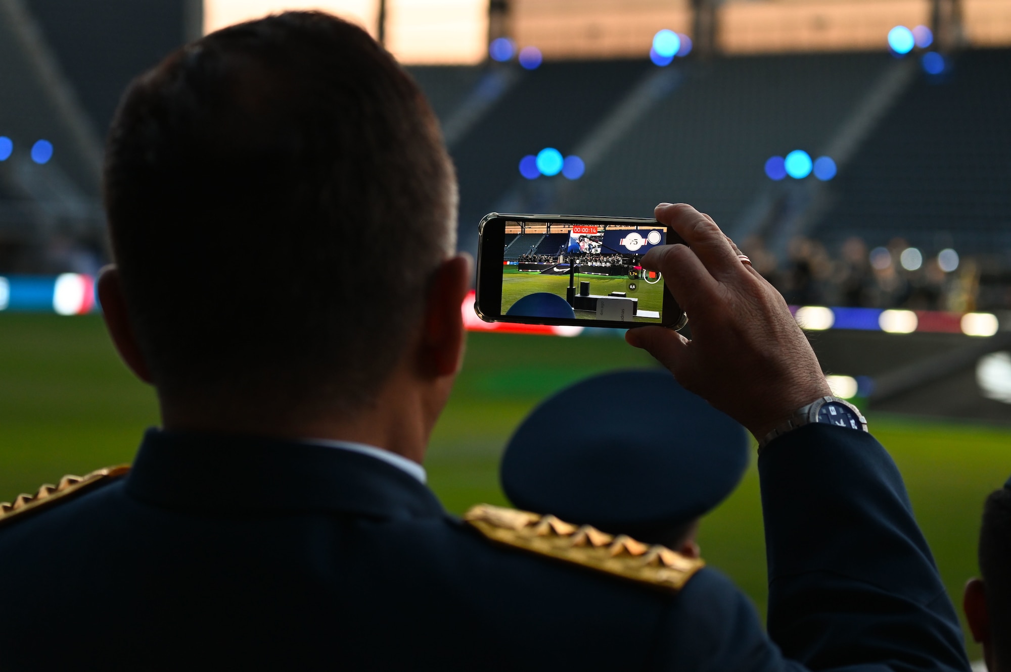One of the international air chiefs in attendance at the Air Force 75th Anniversary Tattoo records The United States Air Force Band performance Sept. 15, 2022, at Audi Field, Washington, D.C. Nearly 50 international air chiefs were in attendance at the Tattoo in honor of the unity and collective power the U.S. has built with its international partners and allies. (U.S. Air Force photo by Staff Sgt. Nilsa Garcia)