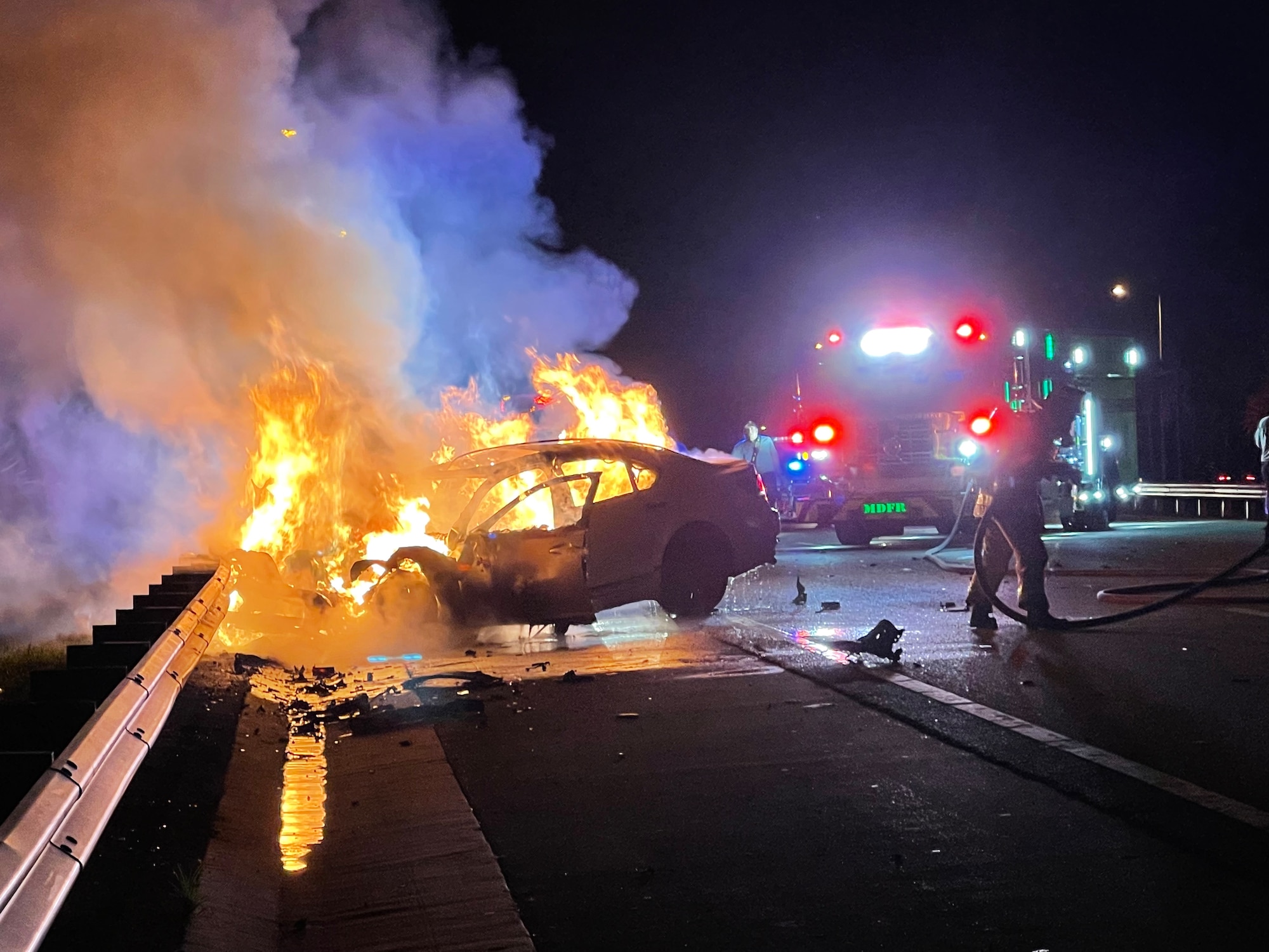 Scene of fiery car crash where Tech. Sgt. Leo Castellno, 482nd Fighter Wing Public Affairs Specialist, and Senior Airman Randy Rodriguez, 70th Aerial Port Squadron Aerial Porter, saved a woman in the early hours of Sept. 10, 2022. (Courtesy photo by Senior Airman Randy Rodriguez)
