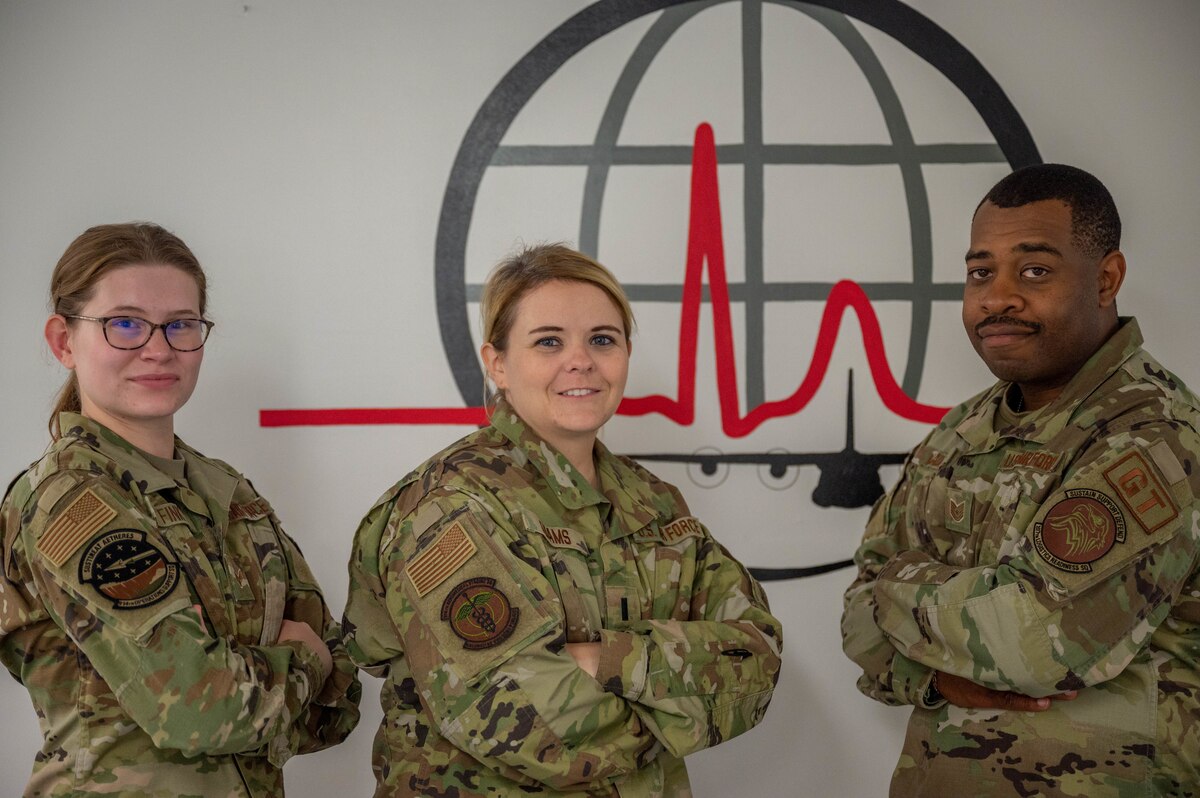Three Airmen stationed at Niagara Falls ARS who combined their skills and abilities to assist in an off-base medical emergency pose for a group photo.