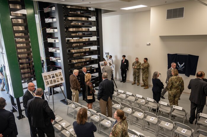 Commemoration ceremony attendees view deadweight testers at the Air Force Primary Standards Lab at Heath, Ohio Sept. 12, 2022.