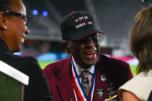 James H. Harvey III, one of the original Tuskegee Airmen, greets attendees of the Air Force 75th Anniversary Tattoo Sept. 15, 2022, at Audi Field, Washington, D.C. Harvey was one of two veterans recognized during the Tattoo for his exemplary service as a pilot with first Black military aviators in the U.S. Army Air Corps. (U.S. Air Force photo by Staff Sgt. Nilsa Garcia)
