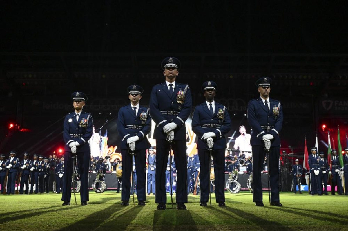 The United States Air Force Band and The United States Air Force Honor Guard Drill Team gather in formation during a performance for the Air Force 75th Anniversary Tattoo Sept. 15, 2022, at Audi Field, Washington, D.C. The military Tattoo is an historic tradition held worldwide, showcasing the excellence and readiness of service members. The members of the band and the honor guard share a common mission of representing Air Force values and fostering community across the nation and with international allies. (U.S. Air Force photo by Airman Bill Guilliam)