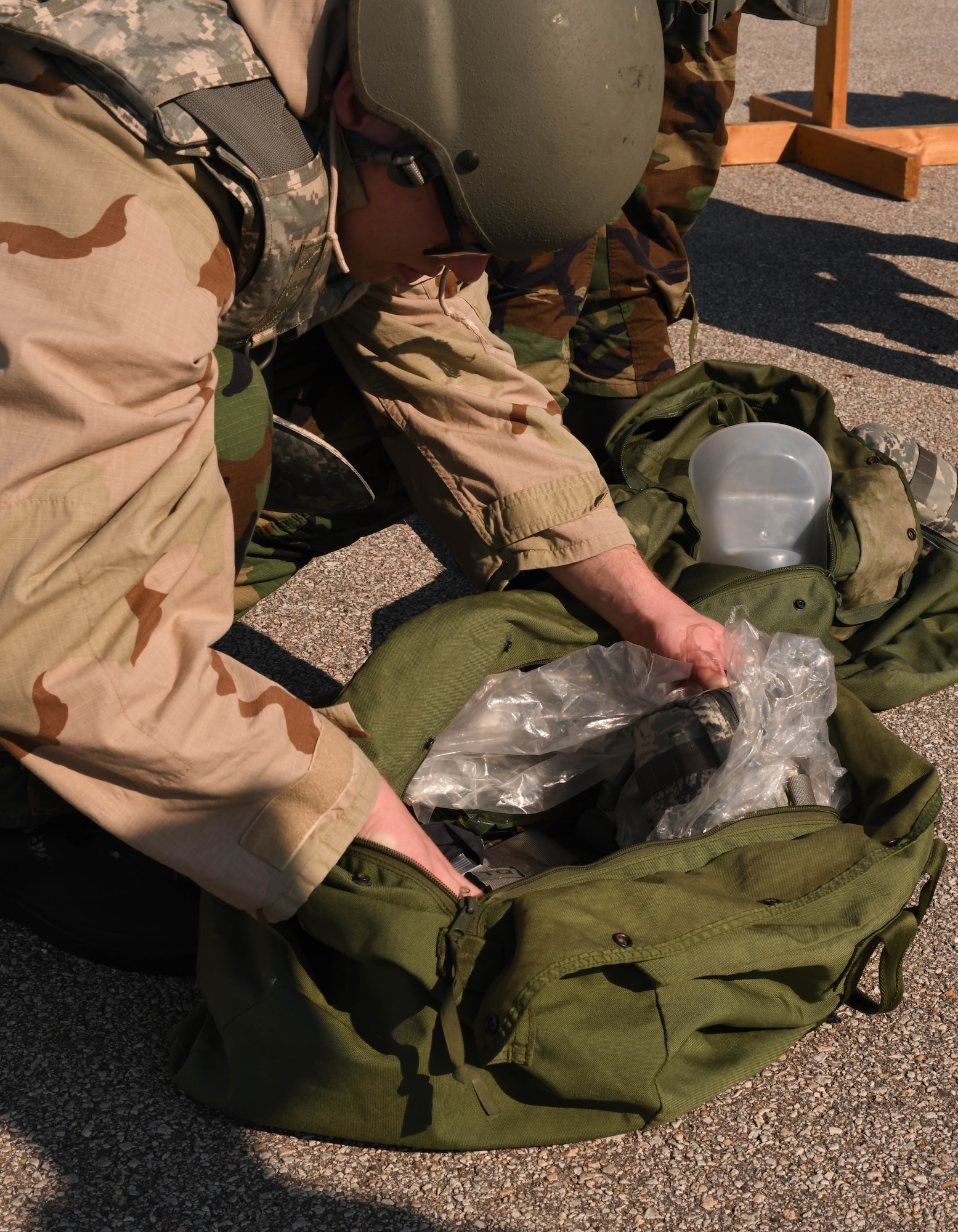 U.S. Air Force Airmen don MOPP gear during a CBRN exercise at Whiteman Air Force Base, Missouri, September, 15, 2022. MOPP gear is protective equipment worn in CBRN-contaminated environments meant to protect an individual from CBRN agents. Utilizing MOPP gear ensures Airmen are ready to respond and defend its personnel and assets. (U.S. Air Force photo by Airman 1st Class Hailey Farrell)