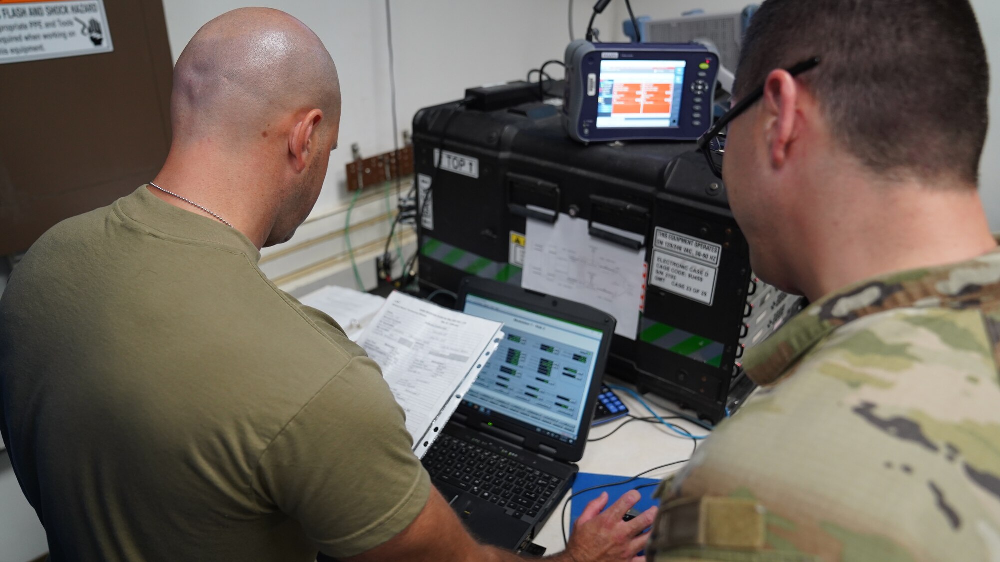 U.S. Air Force Airmen 1st Class Jared Dorosz and Matthew Mason, 338th Training Squadron Radio Frequency Transmission Systems students, practice with radio equipment at Keesler Air Force Base, Mississippi, Sept. 6, 2022. The 338th TRS specializes in two pipeline courses, RF Transmissions Systems and Network Operations.