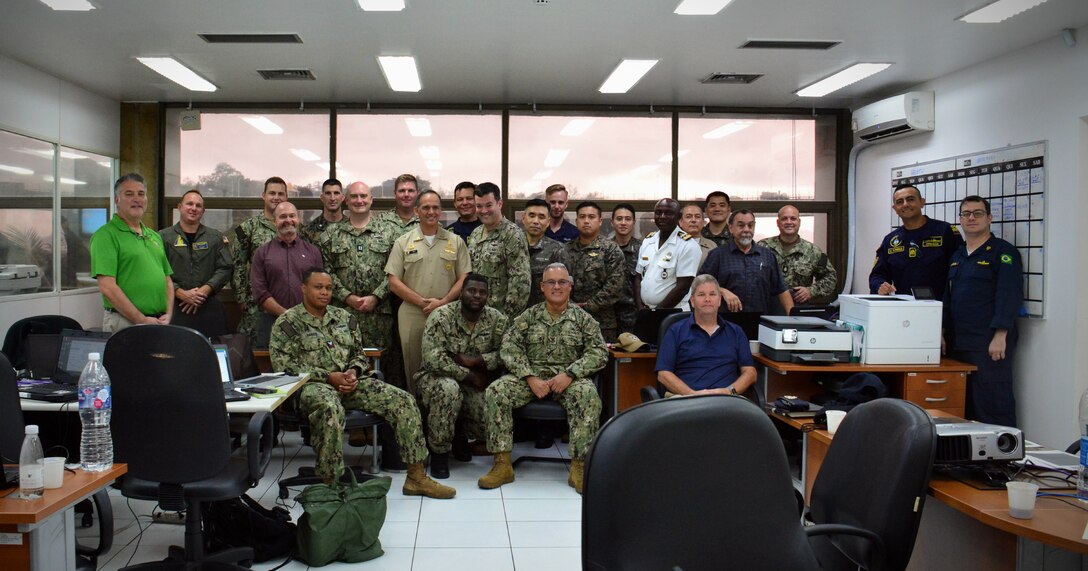 RIO DE JANEIRO (Sept. 14, 2022) UNITAS LXIII exercise control group poses for a photo, Sept. 14, 2022. UNITAS is the world’s longest-running maritime exercise. Hosted this year by Brazil, it brings together multinational forces from Belize, Brazil, Cameroon, Chile, Colombia, Dominican Republic, Ecuador, France, Guyana, Jamaica, Mexico, Namibia, Panama, Paraguay, Peru, South Korea, Spain, United Kingdom, Uruguay, and the United States conducting operations in and off the coast of Rio de Janeiro. The exercise trains forces to conduct joint maritime operations through the execution of anti-surface, anti-submarine, anti-air, amphibious and electronic warfare operations that enhance warfighting proficiency and increase interoperability among participating naval and marine forces. (U.S. Navy photo by Mass Communication Specialist 3rd Class Jahlena Royer/Released)