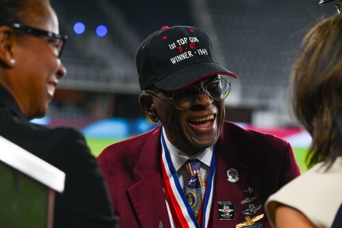 James H. Harvey III, one of the original Tuskegee Airmen, greets attendees of the Air Force 75th Anniversary Tattoo Sept. 15, 2022, at Audi Field, Washington, D.C. Harvey was one of two veterans recognized during the Tattoo for his exemplary service as a pilot with first Black military aviators in the U.S. Army Air Corps. (U.S. Air Force photo by Staff Sgt. Nilsa Garcia)