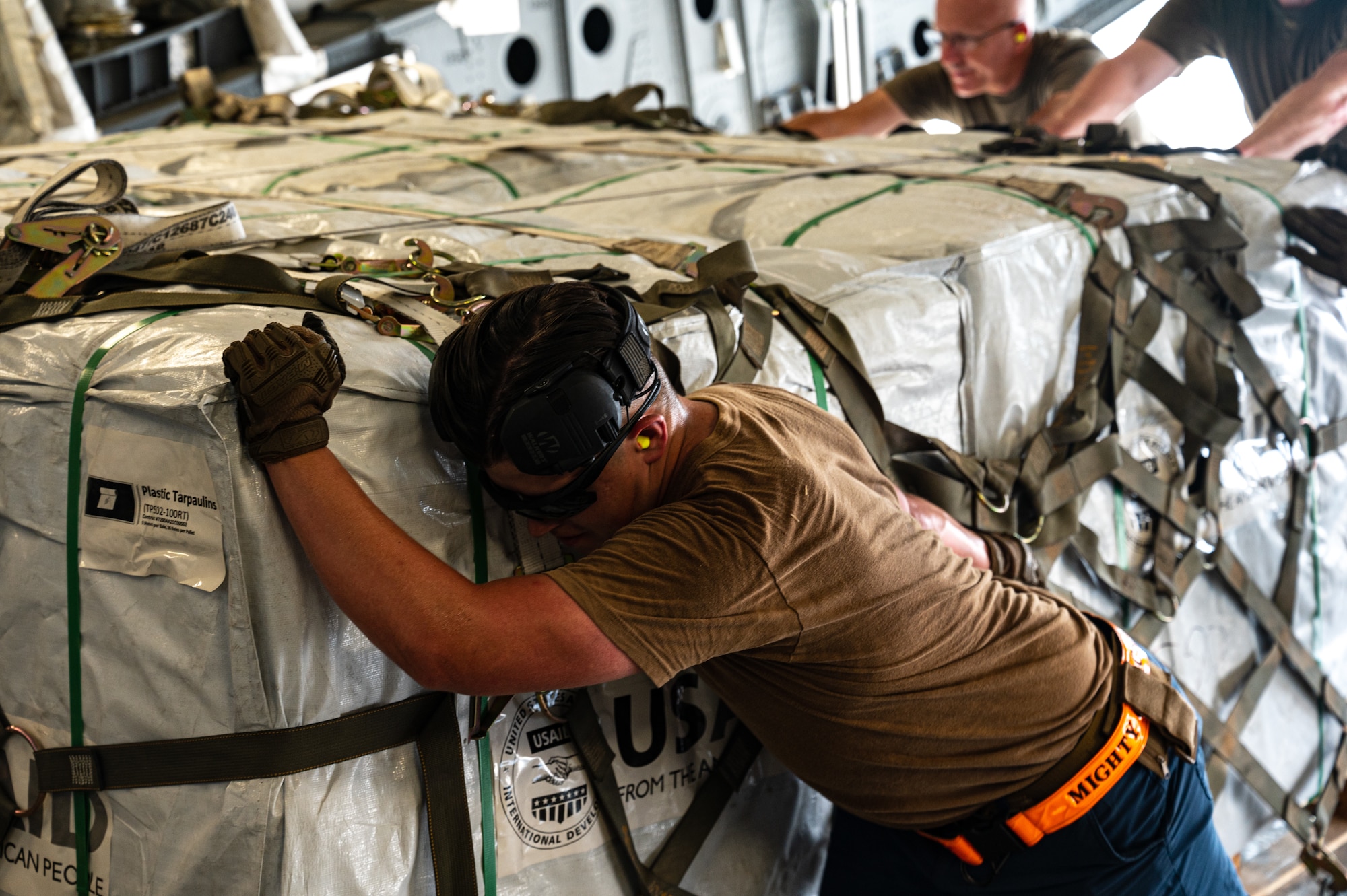 U.S. military personnel assigned to United States Central Command load critical supplies into a U.S. Air Force C-17A Globemaster III aircraft in support of a USAID-led humanitarian mission to Pakistan from Al Udeid Air Base, Qatar, Sep. 14, 2022. USAID leads the U.S. Government's international development and disaster assistance, helping people emerge from humanitarian crises, such as the catastrophic flooding currently plaguing Pakistan. (U.S. Air Force photo by Staff Sgt. Dana Tourtellotte)