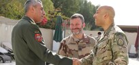British Brig. Gen. Karl Harris, the deputy commanding general of Combined Joint Task Force – Operation Inherent Resolve (CJTF-OIR), and Jordan Brig. Gen. Raed Saud Alijbour, defense attaché, shake hands before the defense attaché forum begins in Baghdad, Iraq, March 17, 2022. The defense attaché forum serves as an opportunity to build-relationships among Global Coalition members, and as a gateway to discuss topics pertaining to the enduring defeat of Da’esh including Combined Joint Task Force – Operation Inherent Resolve’s progress and areas of needed improvement. (U.S. Army photo by Staff Sgt. Bree-Ann Ramos-Clifton)