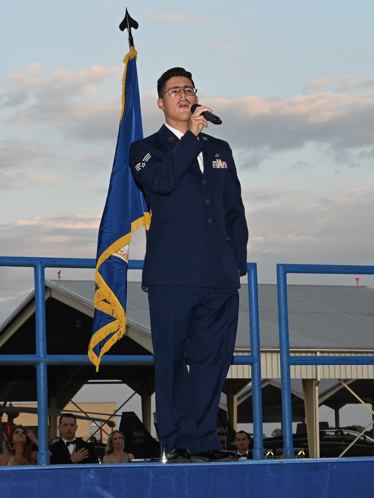 An Airman sings The Star Spangled Banner at the Air Force Ball at Whiteman Air Force Base, Missouri, September 16, 2022. The AF Ball not only celebrates the 75th anniversary of the Air Force being established, but also the 80th anniversary of Whiteman AFB being established. (U.S. Air Force photo by Airman 1st Class Joseph Garcia)