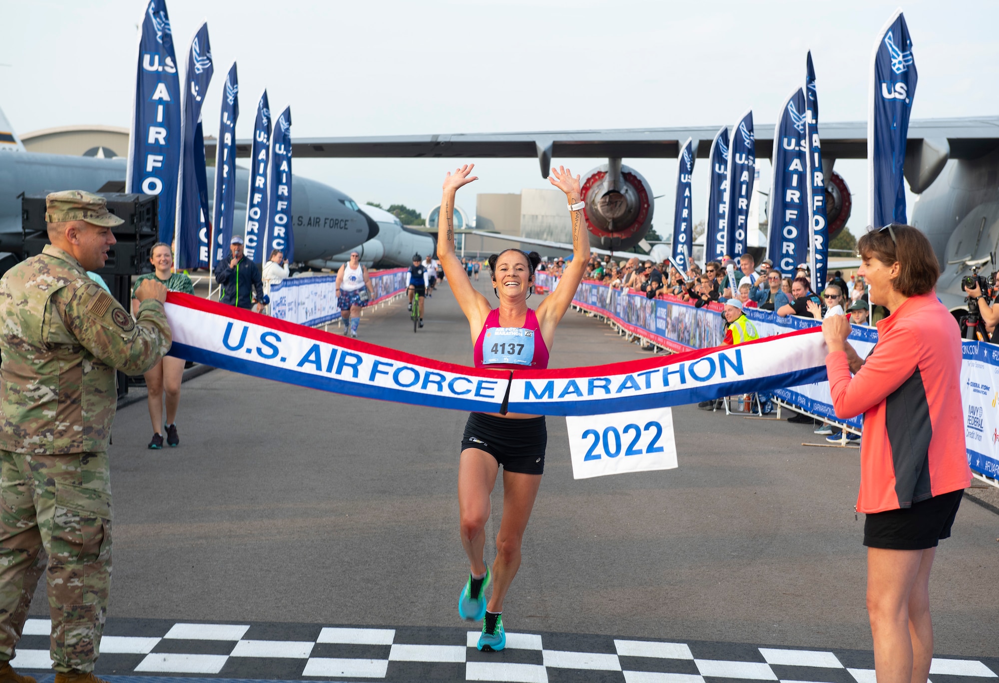 Rebecca Murray celebrates her finish of 1 hours, 18 minutes, 30 seconds as she becomes the first female to cross the line Sept. 17 in the 2022 half-marathon division. She competed among thousands of runners in the 26th annual Air Force Marathon at Wright-Patterson Air Force Base, Ohio.