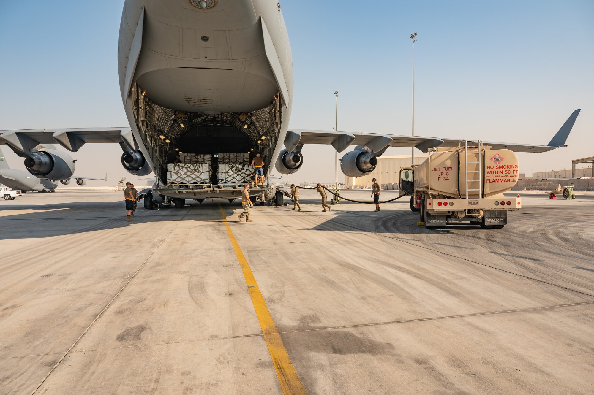 U.S. military personnel assigned to United States Central Command prepare a U.S. C-17A Globemaster III aircraft, loaded with critical supplies in support of a USAID-led humanitarian mission to Pakistan at Al Udeid Air Base, Qatar, Sep. 14, 2022. USAID leads the U.S. Government's international development and disaster assistance, helping people emerge from humanitarian crises, such as the catastrophic flooding currently plaguing Pakistan. (U.S. Air Force photo by Staff Sgt. Dana Tourtellotte)