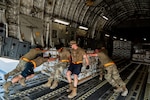 U.S. military personnel assigned to United States Central Command load critical supplies into a U.S. Air Force C-17A Globemaster III aircraft in support of a USAID-led humanitarian mission to Pakistan from Al Udeid Air Base, Qatar, Sep. 14, 2022. USAID leads the U.S. Government's international development and disaster assistance, helping people emerge from humanitarian crises, such as the catastrophic flooding currently plaguing Pakistan. (U.S. Air Force photo by Staff Sgt. Dana Tourtellotte)