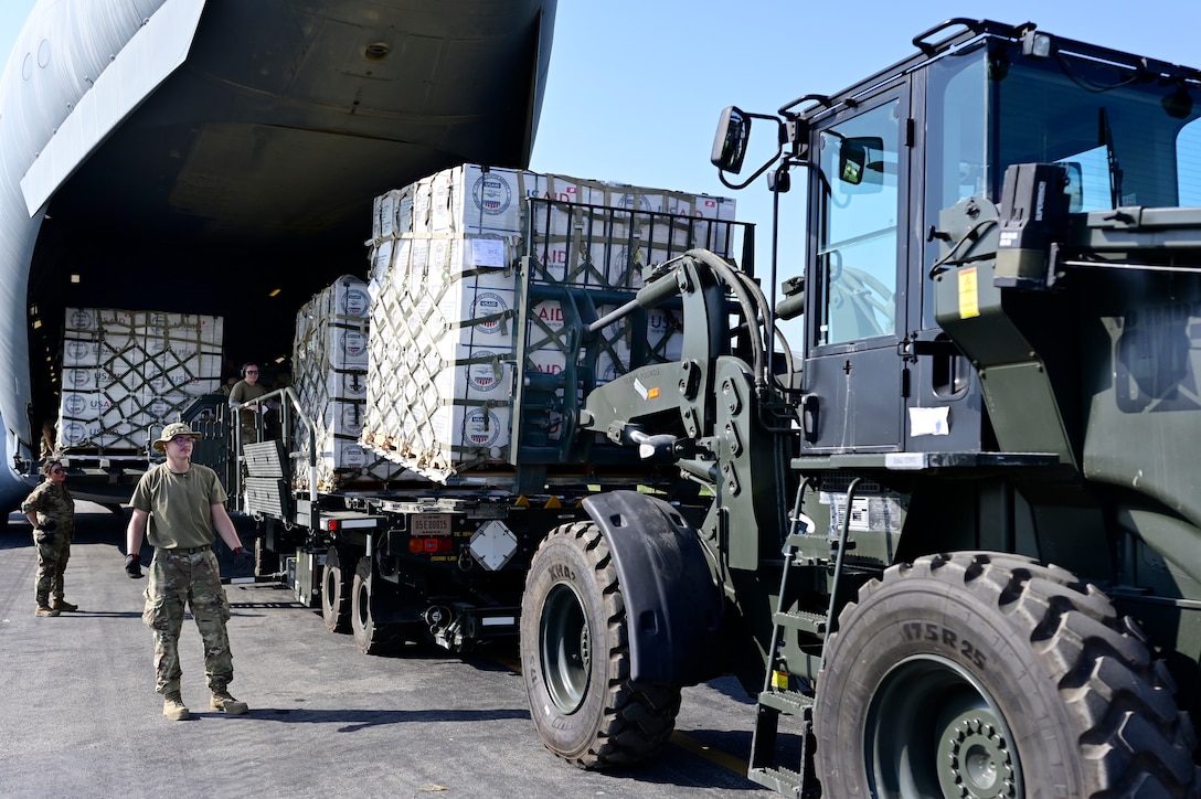 U.S. military personnel assigned to United States Central Command unload critical supplies off a U.S. Air Force C-17A Globemaster III aircraft in support of a USAID-led humanitarian mission at Sukkur Airport, Pakistan, Sep. 10, 2022. USAID leads the U.S. Government's international development and disaster assistance, helping people emerge from humanitarian crises, such as the catastrophic flooding currently plaguing Pakistan. (U.S. Air Force photo by Master Sgt. Matthew Plew)