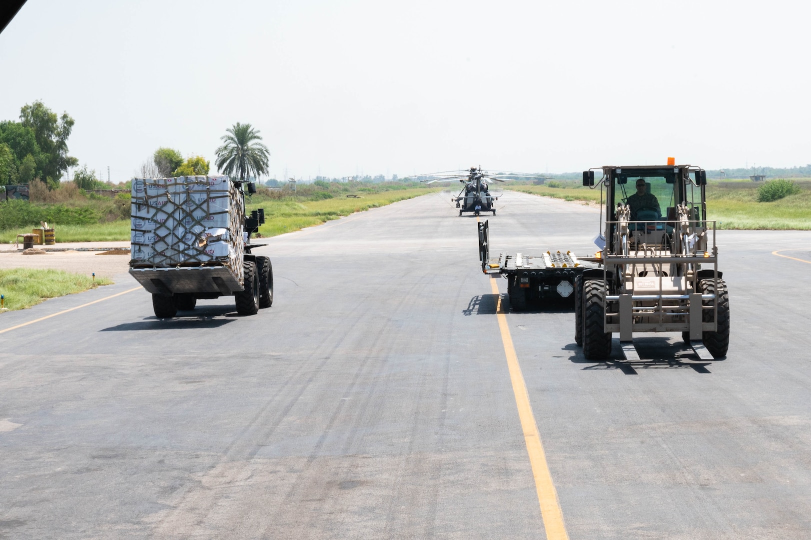 U.S. military personnel assigned to United States Central Command deliver equipment in support of a USAID-led humanitarian mission at Sukkur Airport, Pakistan, Sep. 10, 2022. USAID leads the U.S. Government's international development and disaster assistance, helping people emerge from humanitarian crises, such as the catastrophic flooding currently plaguing Pakistan. (U.S. Air Force photo by Staff Sgt. Cassandra Johnson)