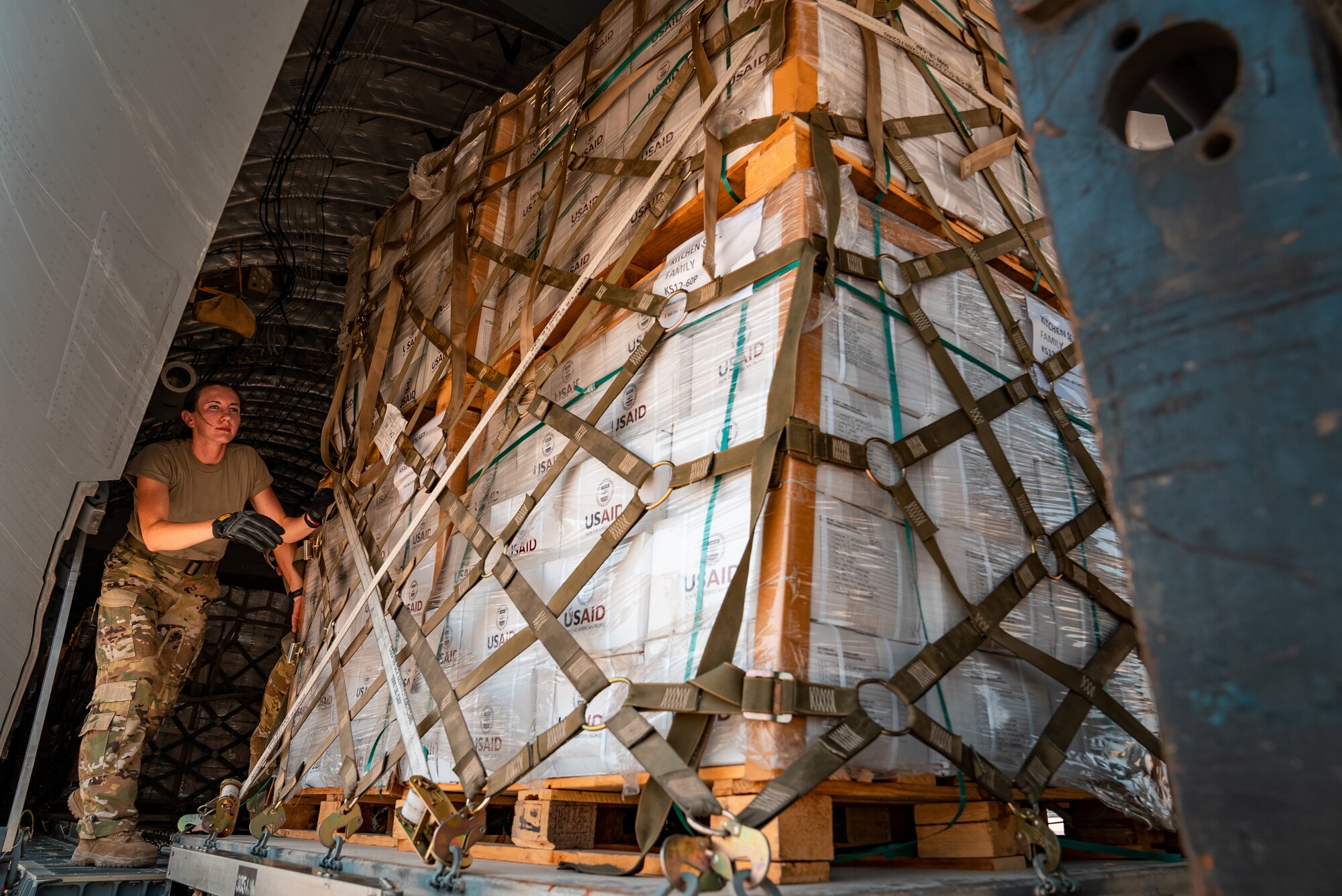 U.S. military personnel assigned to United States Air Forces Central Command unload critical supplies at Karachi Airport, Pakistan, in support of a USAID-led humanitarian mission in Pakistan, Sep. 15, 2022. USAID leads the U.S. Government's international development and disaster assistance, helping people emerge from humanitarian crises, such as the catastrophic flooding currently plaguing Pakistan. (Courtesy photo by Narender Kumar)