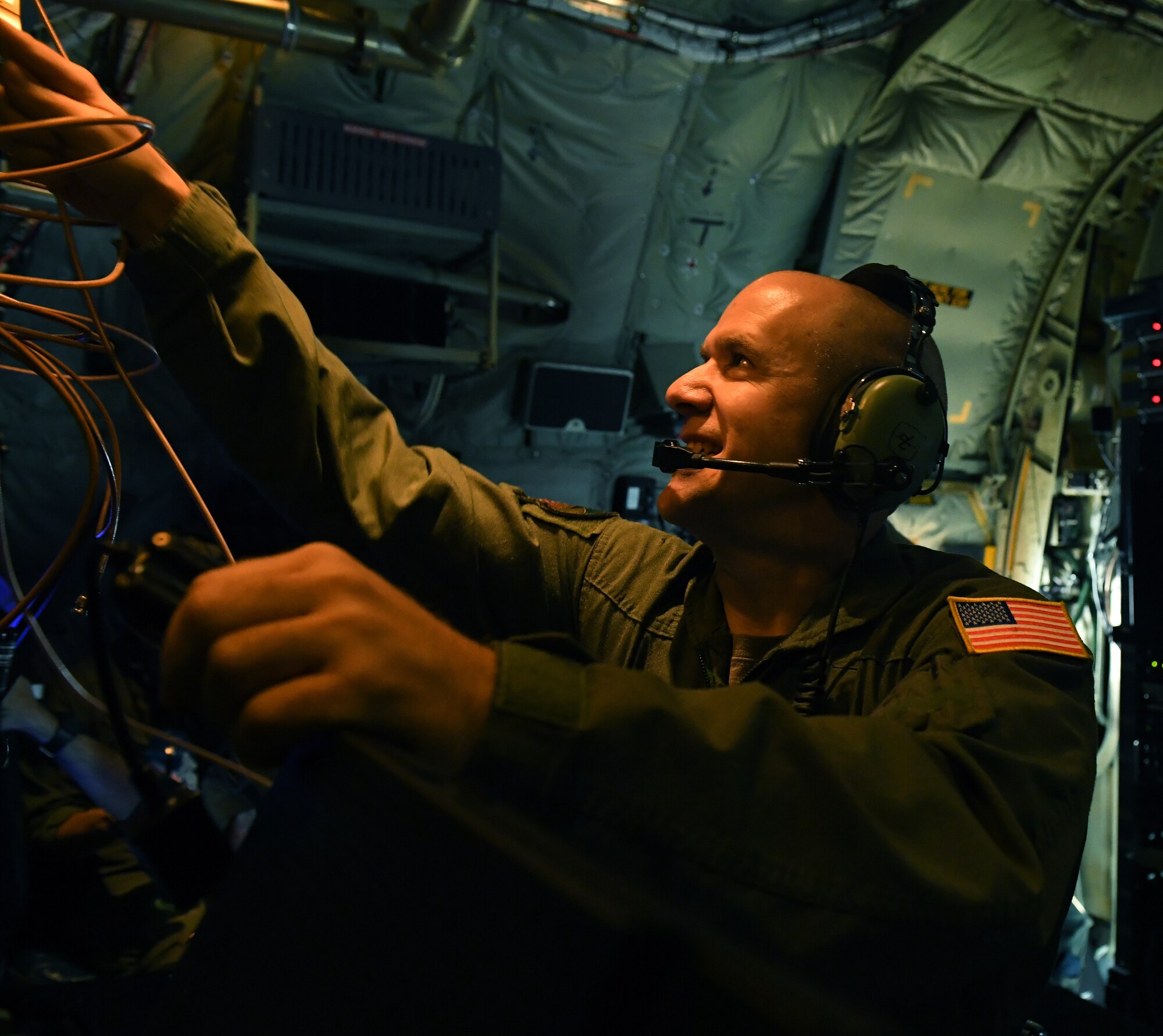 U.S. Air Force Master Sgt. Aaron Harman, an Electronic Communication Systems operator with the 193rd Special Operations Group, pulls patch cables during the EC-130J Commando Solo aircraft final training flight in Middletown, Pennsylvania, Sept. 17, 2022.