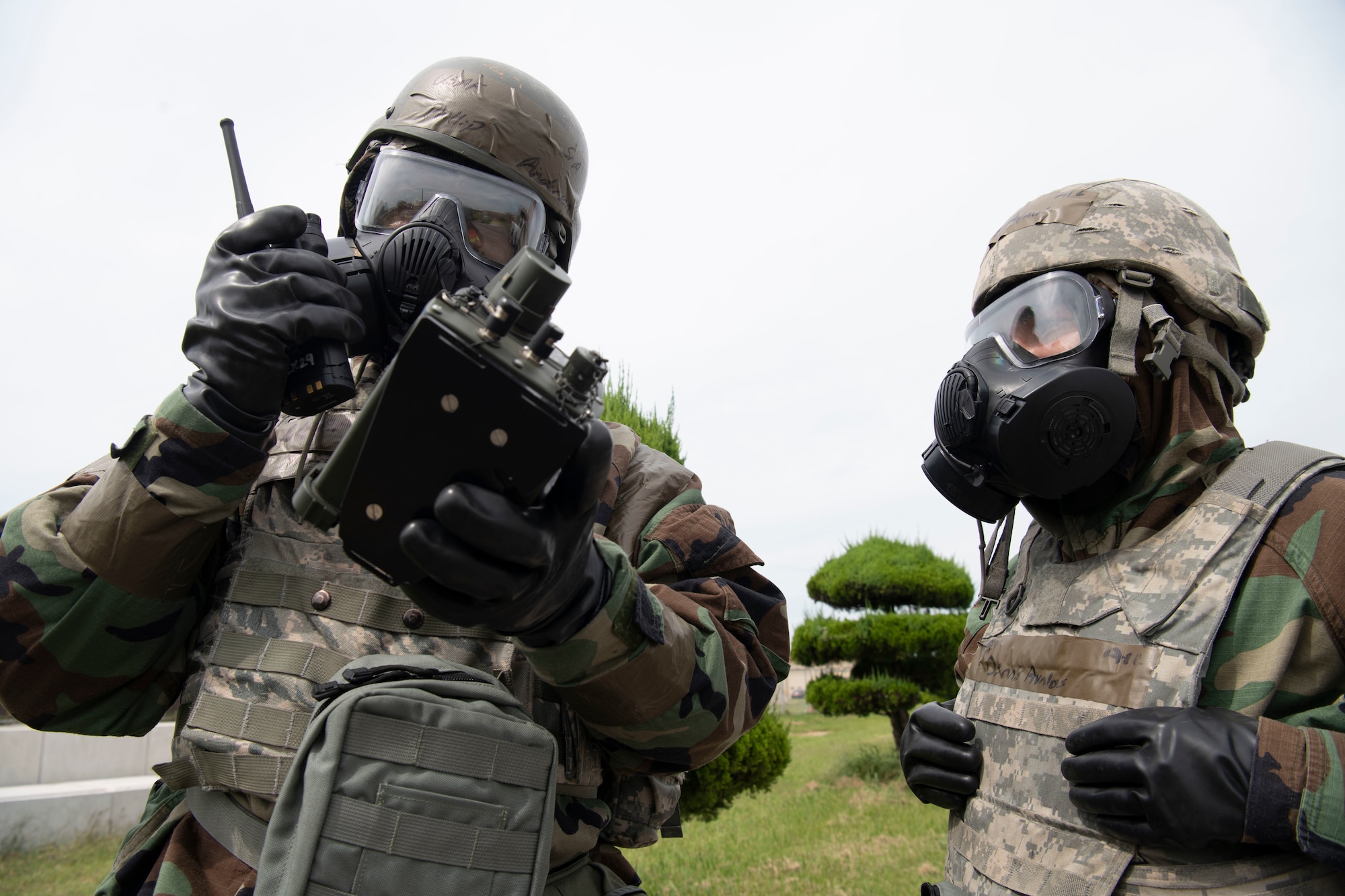 U.S. Air Force Senior Airman Phillip Anderson (left), 8th Logistic Readiness Squadron flight service center technician and emergency management (EM) augmentee, and U.S. Air Force Airman 1st Class Dennis Avalos, 8th Communications Squadron client systems technician and EM augmentee, reports a chemical agent detector reading during a training event at Kunsan Air Base, Republic of Korea, Sept. 14, 2022. Augmentees act as force multipliers and allow a smaller group of Airmen to execute the mission in a safe and efficient manner. (U.S. Air Force photo by Staff Sgt. Sadie Colbert)