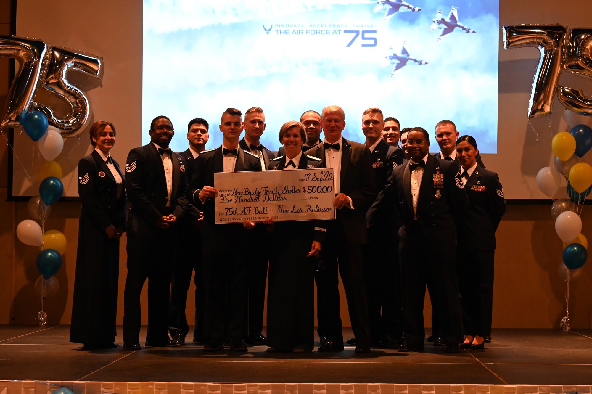 Retired U.S. Air Force Gen. Lori Robinson, guest speaker and former 17th Training Wing commander, receives a check on behalf of a charity from the Air Force Ball committee, during the annual Air Force Ball, at the McNease Convention Center, in San Angelo, Texas, Sept. 17, 2022. Over the past years, Goodfellow Air Force Base has trained more than 18,000 pilots, 60,000 firefighters, and 360,000 intelligence, surveillance, and reconnaissance warriors, serving at nearly every Department of Defense installation across the globe. (U.S. Air Force photo by Airman 1st Class Zachary Heimbuch)