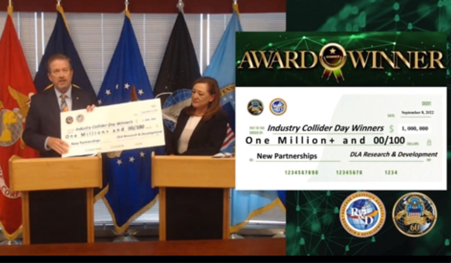 Brad Bunn, DLA vice director, and Roxanne Banks, DLA deputy director of acquisition, hold large check representing the $1 million in contracts granted to eight small businesses on Industry Collider Day.