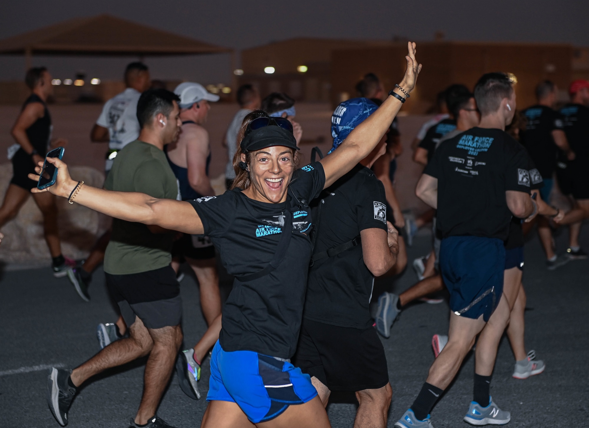 U.S. Air Force Maj. Ashleigh Peck, Air Forces Central Command Deputy Director of Public Affairs, strikes a pose during a morale run, Sept. 17, 2022 at Al Udeid Air Base, Qatar. The run commemorated the creation of the U.S. Air Force from the Army Air Corps 75 years ago.  (U.S. Air National Guard photo by Master Sgt. Michael J. Kelly)