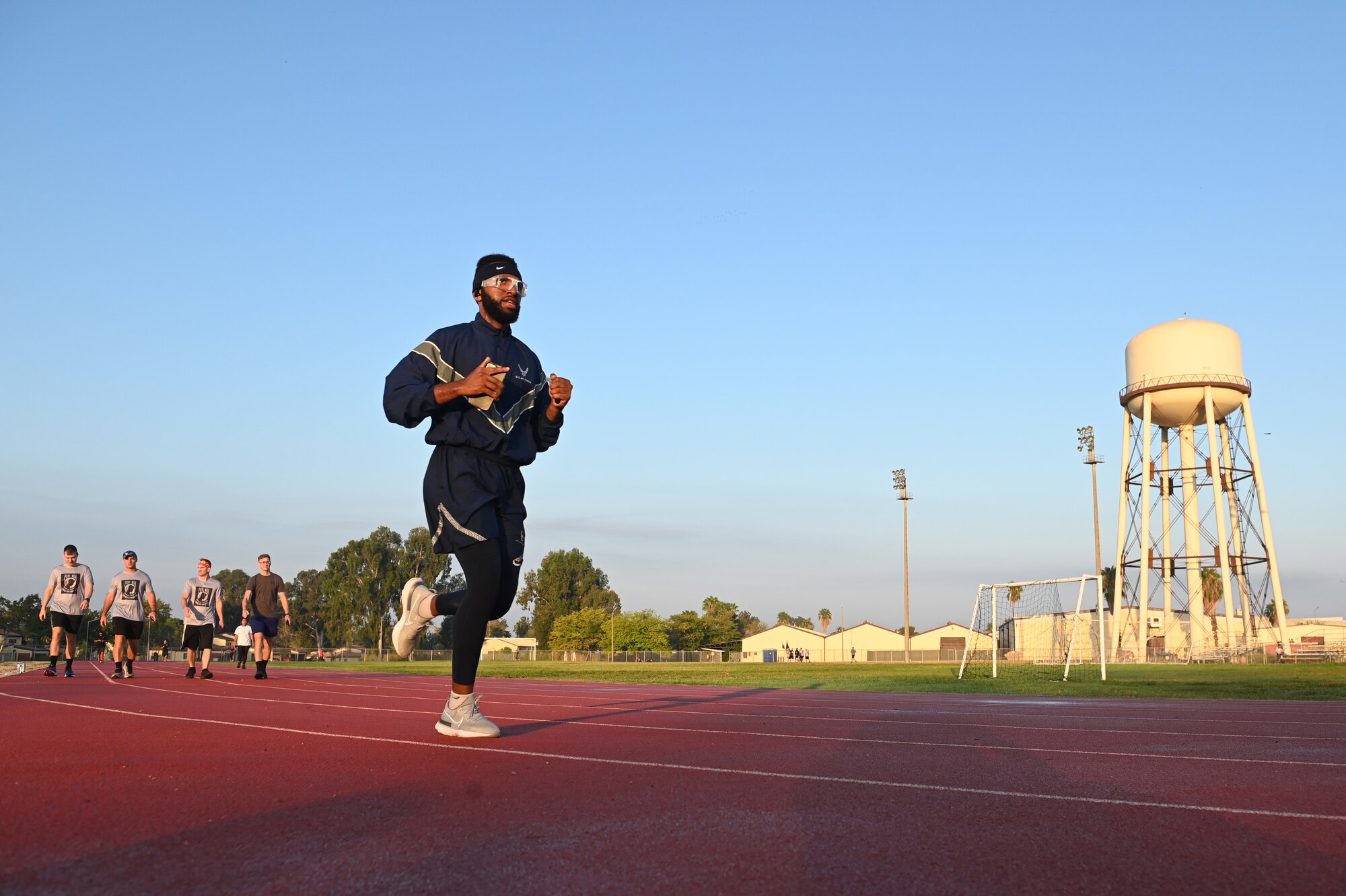 People run on a track.