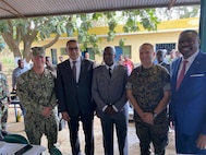 Maj. Ryan Holland and Builder Chief Petty Officer Gabrial Miller pose for a group photo with the Honorable Carlos Vila Nova, President of Sao Tome and Principe, and the Brigadier Idalécio Pachire, Chief of Staff of the Armed Forces of São Tomé and Príncipe (FASTP).