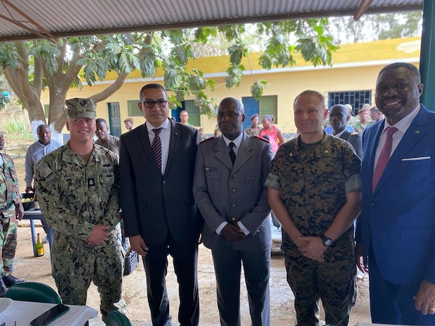 Maj. Ryan Holland and Builder Chief Petty Officer Gabrial Miller pose for a group photo with the Honorable Carlos Vila Nova, President of Sao Tome and Principe, and the Brigadier Idalécio Pachire, Chief of Staff of the Armed Forces of São Tomé and Príncipe (FASTP).