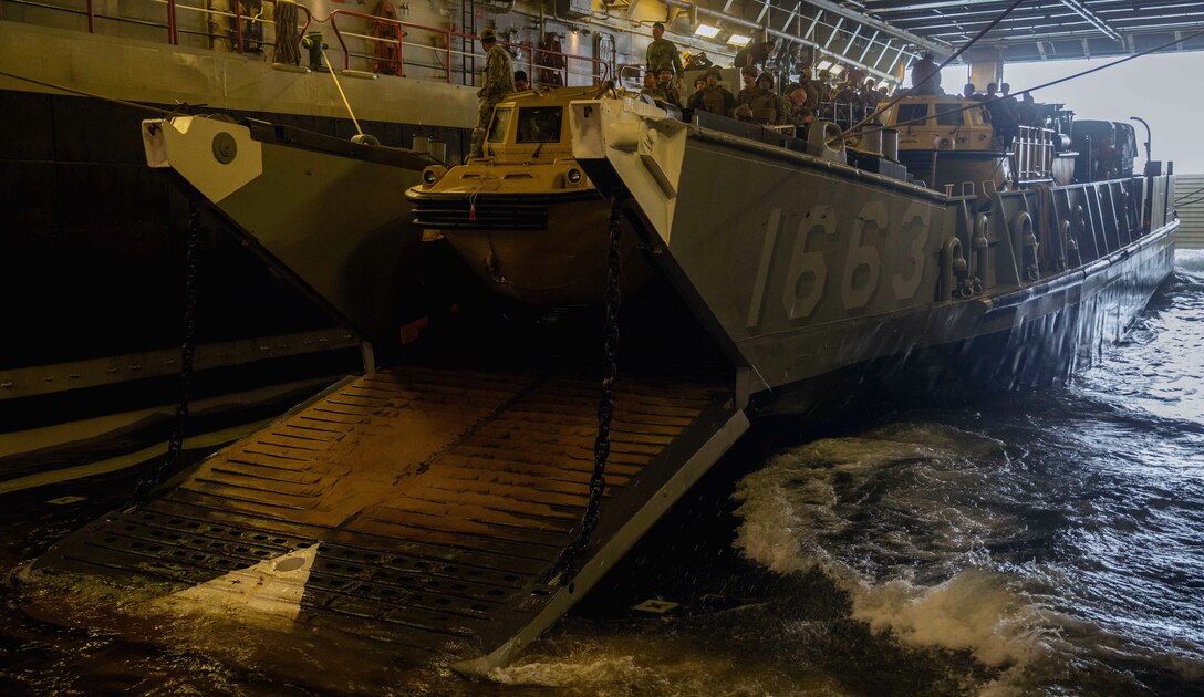ATLANTIC OCEAN (Sept. 16, 2022) -- U.S. Marines prepare to disembark a landing craft, utility (LCU) in the well deck of the amphibious landing dock ship USS Mesa Verde (LPD 19) after returning from a multi-national amphibious assault with Brazilian and Uruguayan marines, Sept. 16, 2022. Mesa Verde is currently underway in the Atlantic Ocean in support of exercise UNITAS LXIII. UNITAS is the world’s longest-running maritime exercise. Hosted this year by Brazil, it brings together multinational forces from Belize, Brazil, Cameroon, Chile, Colombia, Dominican Republic, Ecuador, France, Guyana, Jamaica, Mexico, Namibia, Panama, Paraguay, Peru, South Korea, Spain, United Kingdom, Uruguay, and the United States conducting operations in and off the coast of Rio de Janeiro. The exercise trains forces to conduct joint maritime operations through the execution of anti-surface, anti-submarine, anti-air, amphibious and electronic warfare operations that enhance warfighting proficiency and increase interoperability among participating naval and marine forces. (U.S. Navy photo by Mass Communication Specialist 3rd Class Sydney Milligan)