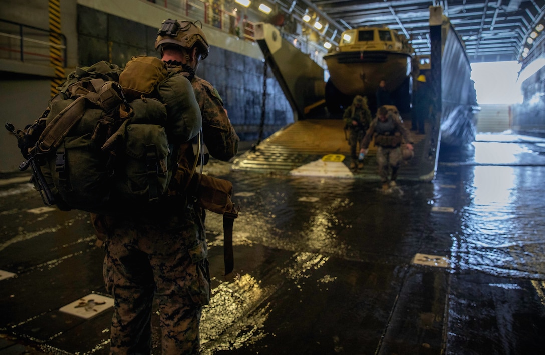 ATLANTIC OCEAN (Sept. 16, 2022) -- U.S. Marines disembark a landing craft, utility (LCU) in the well deck of the amphibious landing dock ship USS Mesa Verde (LPD 19) after returning from a multi-national amphibious assault with Brazilian and Uruguayan marines, Sept. 16, 2022. Mesa Verde is currently underway in the Atlantic Ocean in support of exercise UNITAS LXIII. UNITAS is the world’s longest-running maritime exercise. Hosted this year by Brazil, it brings together multinational forces from Belize, Brazil, Cameroon, Chile, Colombia, Dominican Republic, Ecuador, France, Guyana, Jamaica, Mexico, Namibia, Panama, Paraguay, Peru, South Korea, Spain, United Kingdom, Uruguay, and the United States conducting operations in and off the coast of Rio de Janeiro. The exercise trains forces to conduct joint maritime operations through the execution of anti-surface, anti-submarine, anti-air, amphibious and electronic warfare operations that enhance warfighting proficiency and increase interoperability among participating naval and marine forces. (U.S. Navy photo by Mass Communication Specialist 3rd Class Sydney Milligan)